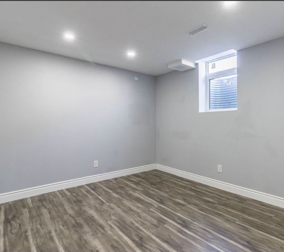 Finished basement bedroom with vinyl plank flooring in Barrie