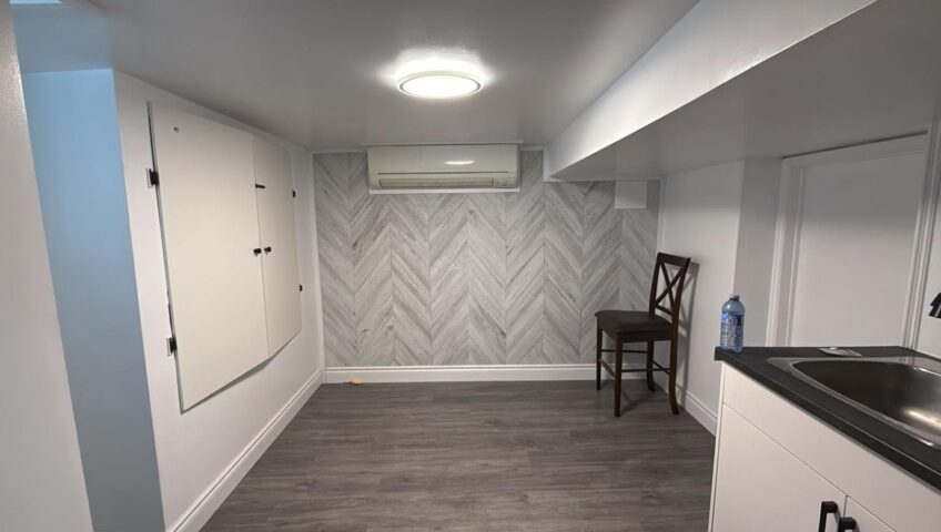 Finished basement living space with accent wall in a Barrie home