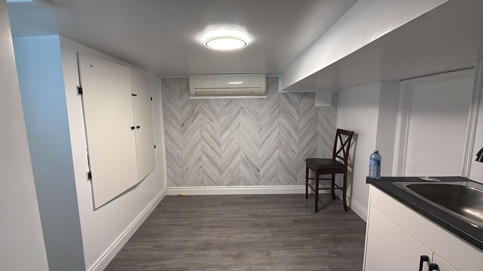 Basement renovation with chevron accent wall and mini-split AC, Barrie