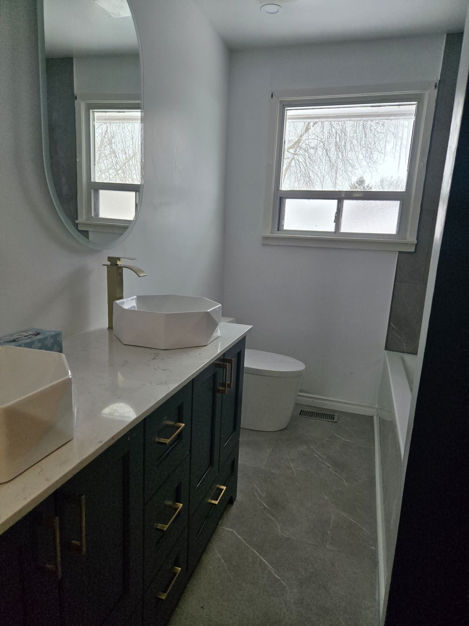 Bathroom with double vessel sinks and gold faucets, Barrie renovation