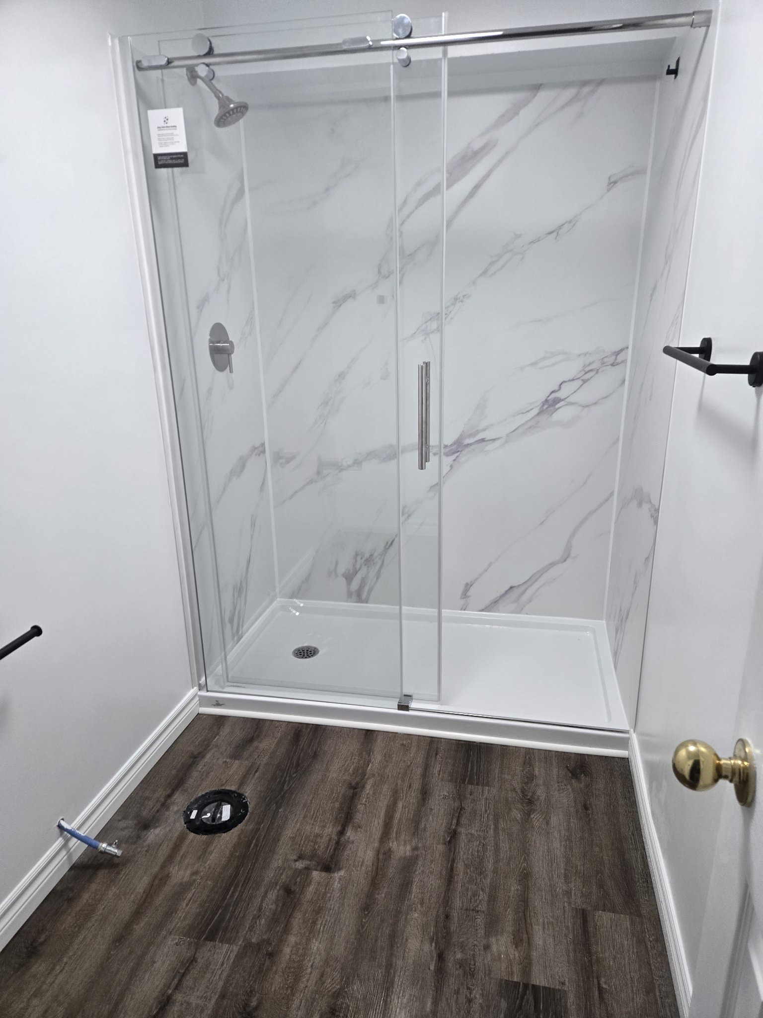 Glass shower enclosure with marble-look panels, bathroom renovation Barrie