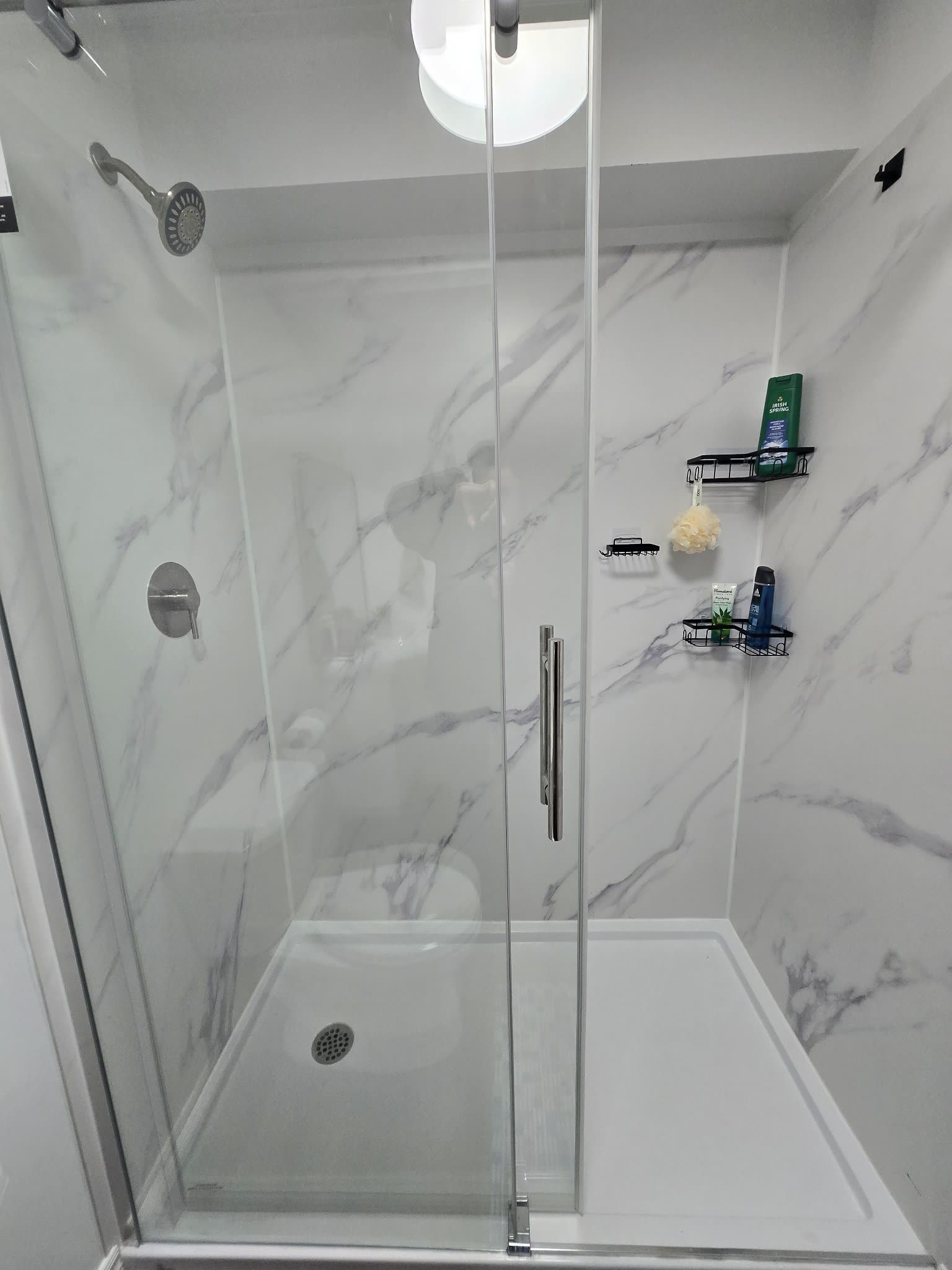 Frameless glass shower with marble tile surround, bathroom reno Barrie