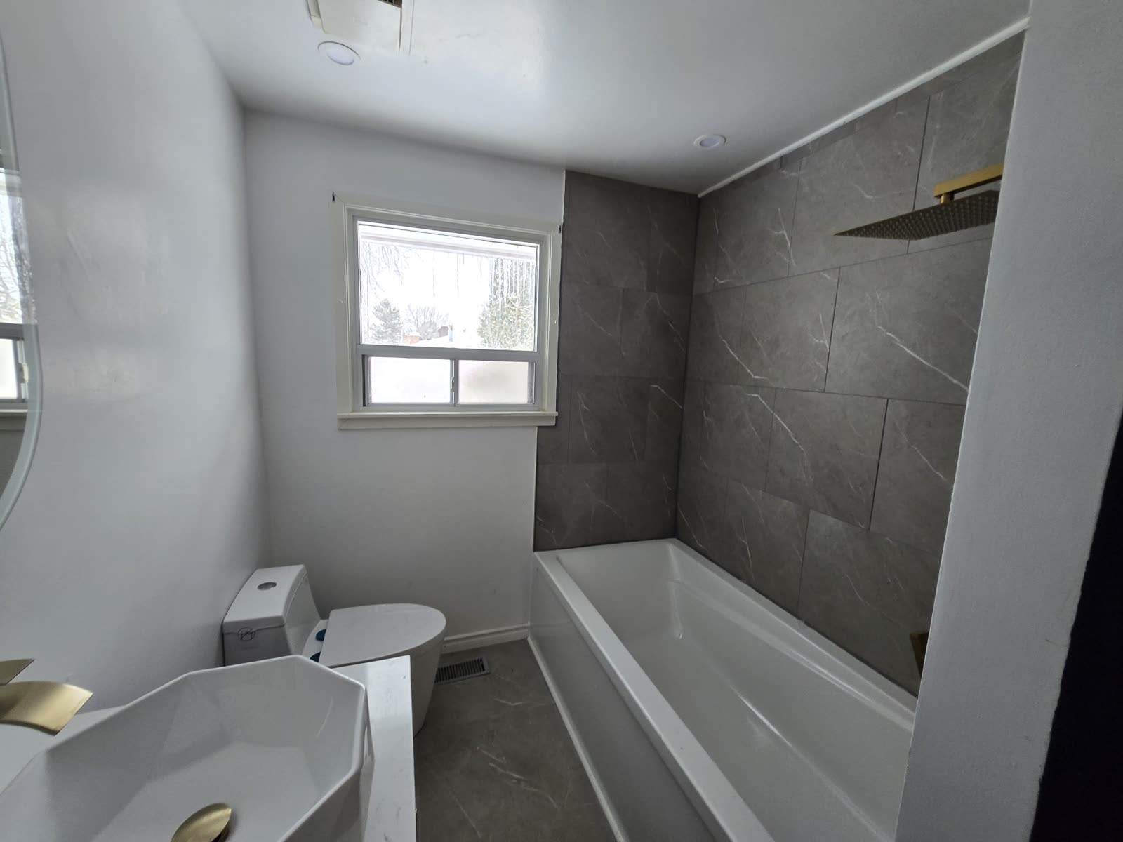 Bathroom with soaking tub and gold rain shower, Barrie Ontario