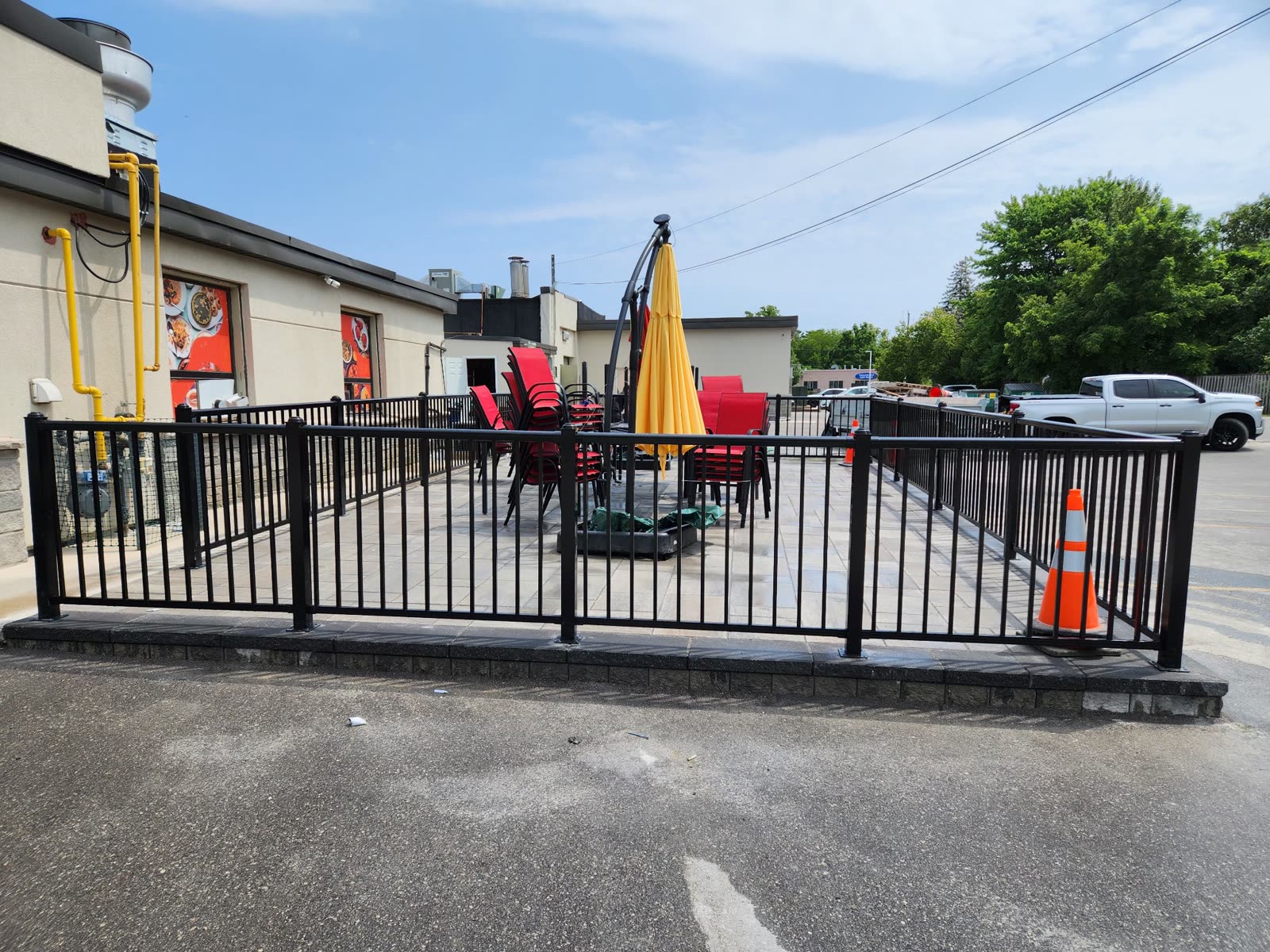 Commercial restaurant patio with interlocking pavers and black railings, Barrie