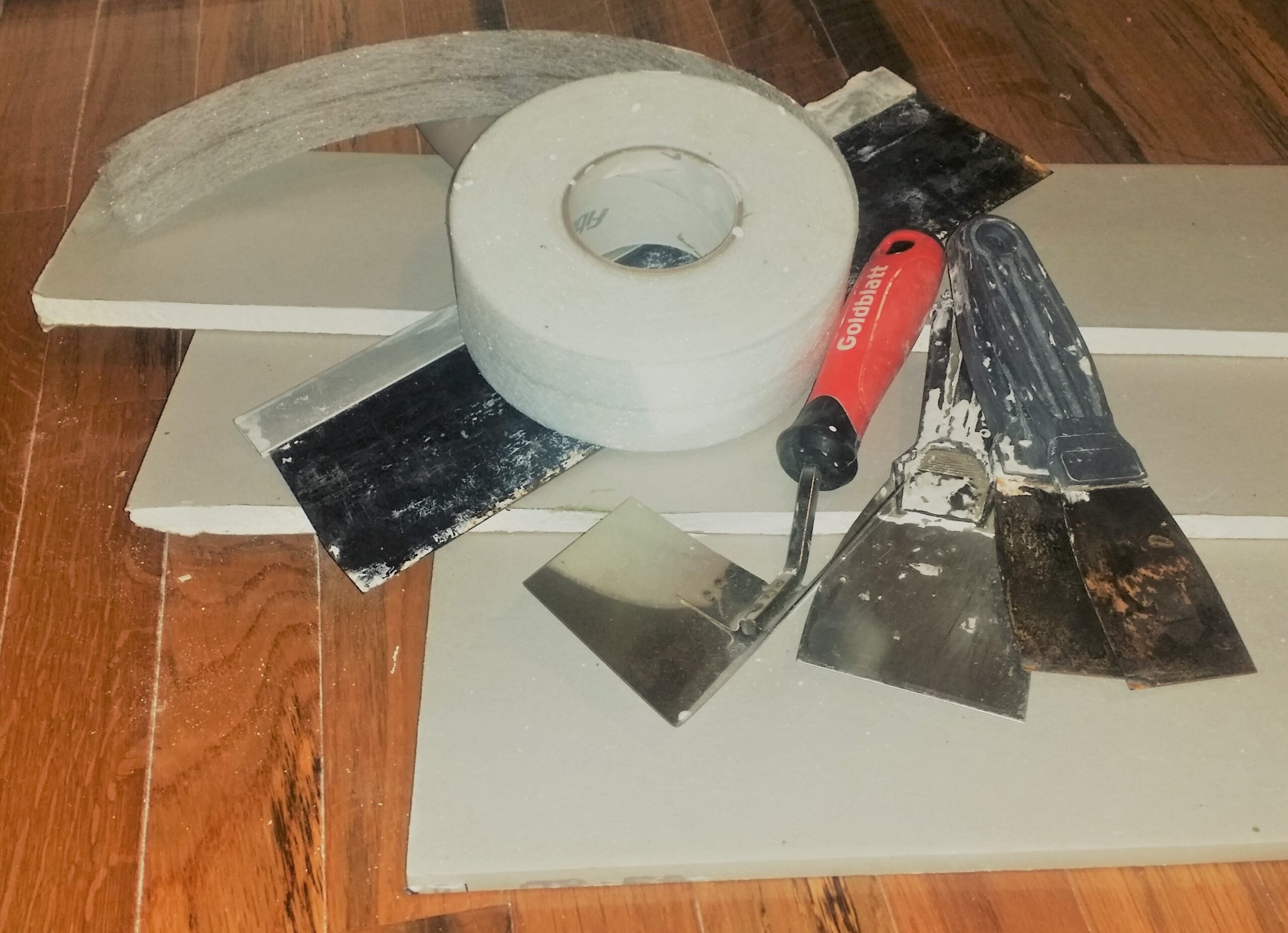 Drywall taping tools — tape roll and taping knives