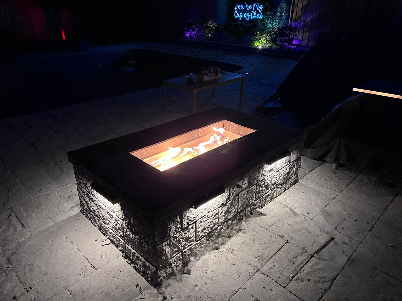 Fire pit glowing at night in Simcoe County backyard