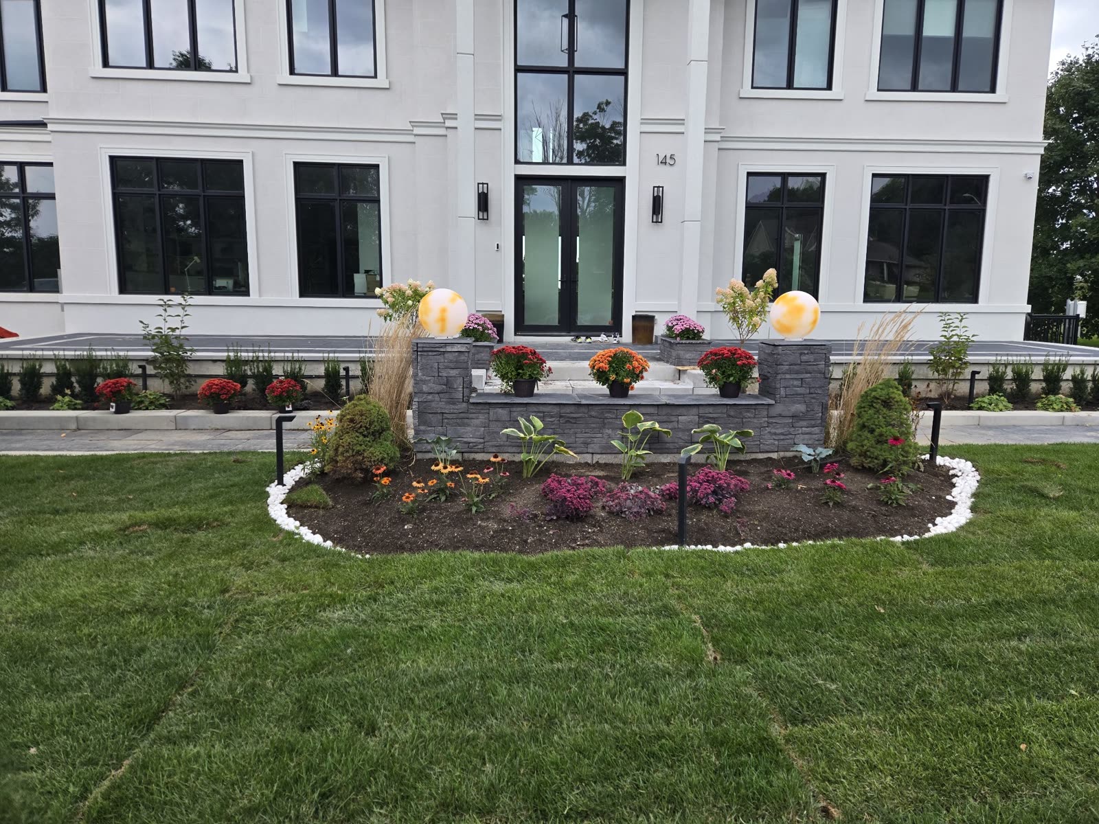 Front yard garden bed with stone retaining wall, Barrie