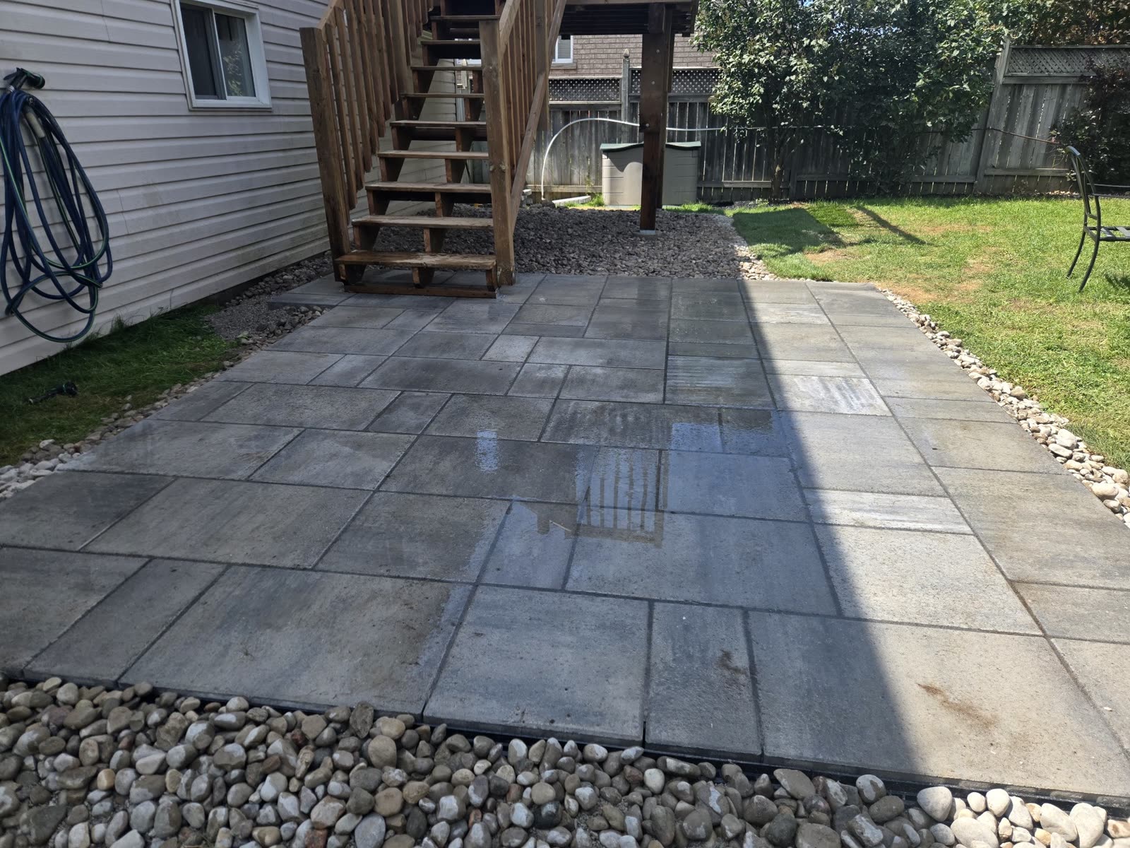 Interlocking patio at base of wooden deck stairs, Barrie
