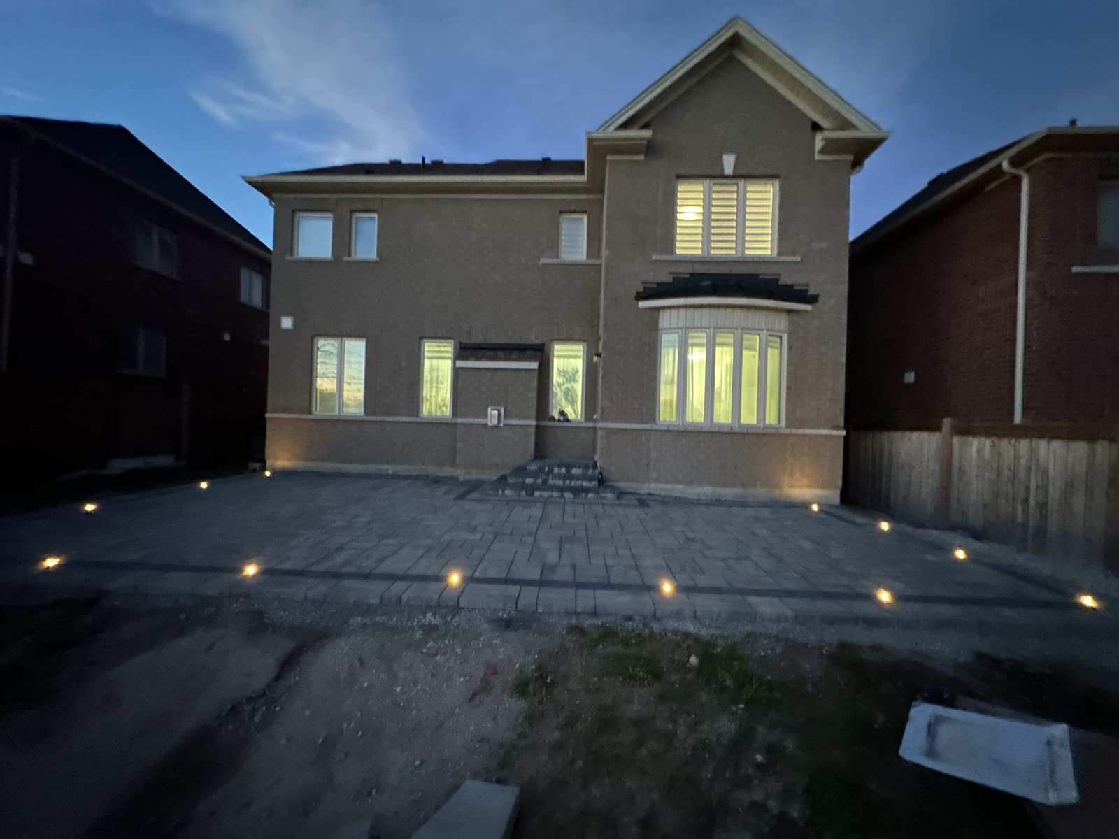Backyard interlocking patio at dusk, Barrie Ontario