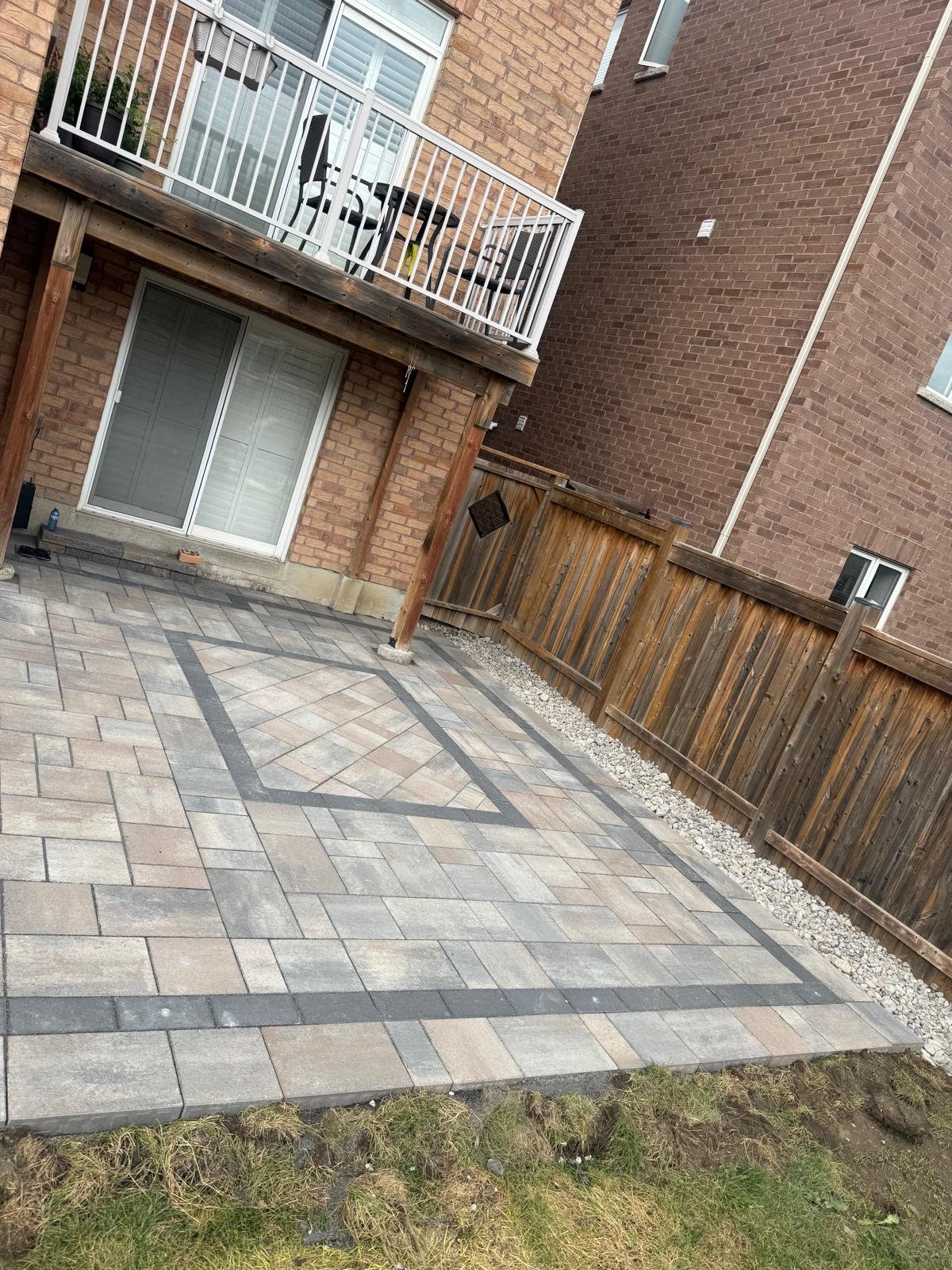 Interlocking patio beside fence, backyard renovation Innisfil