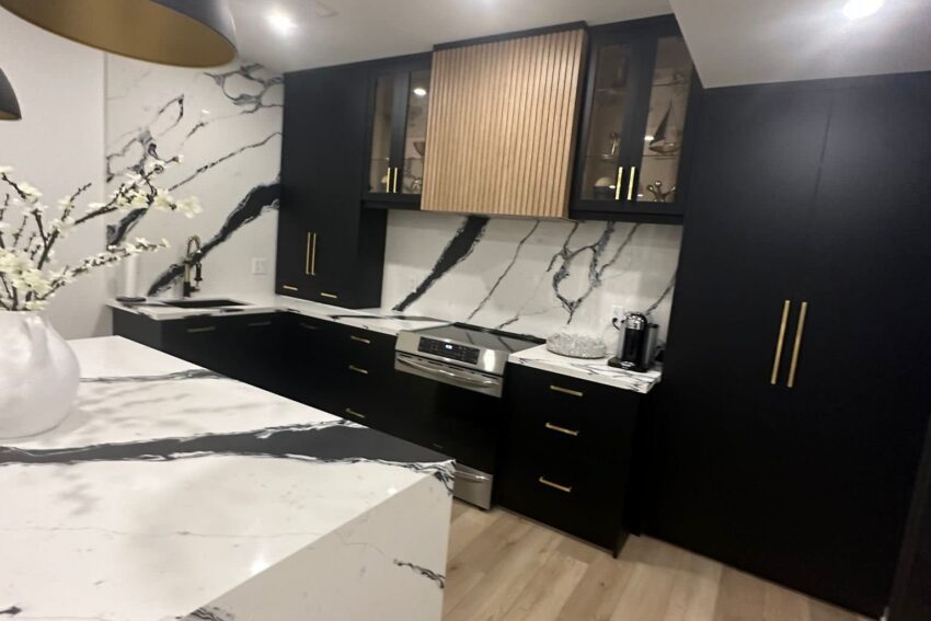 Luxury black and gold kitchen renovation with waterfall island in Barrie