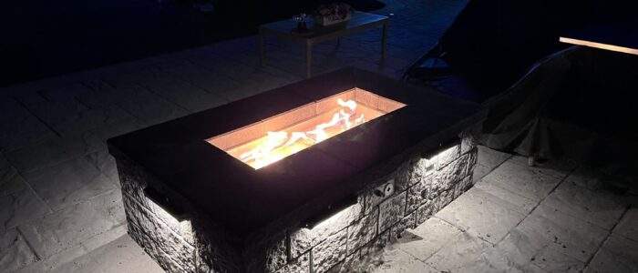 Fire pit with landscape lighting at night