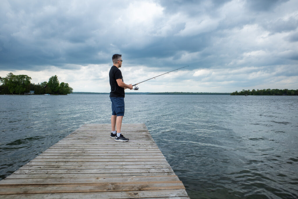 Fisherman casting from a dock on Lake Couchiching, Orillia
