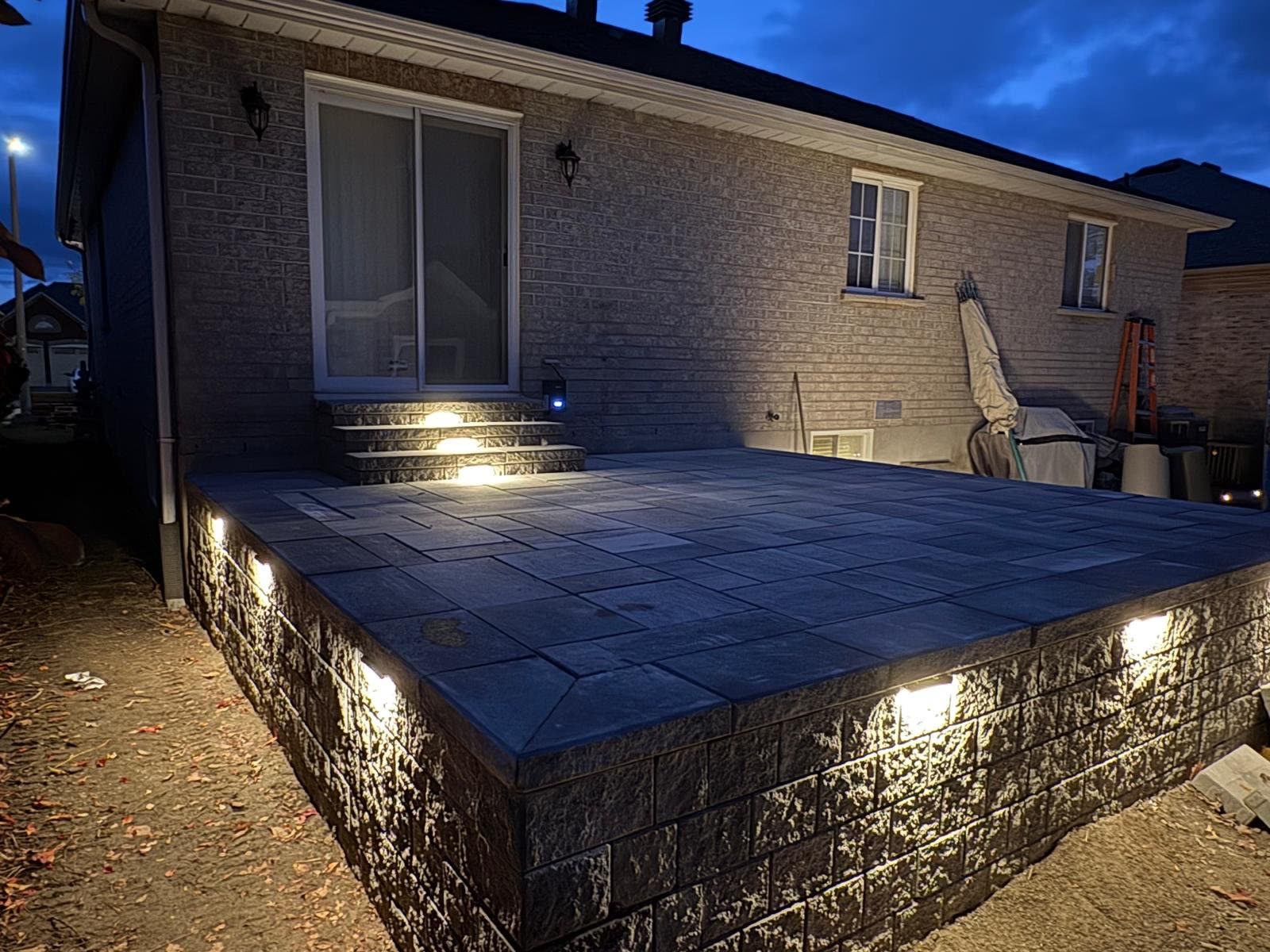 Retaining wall accent lighting on raised patio in Barrie at night