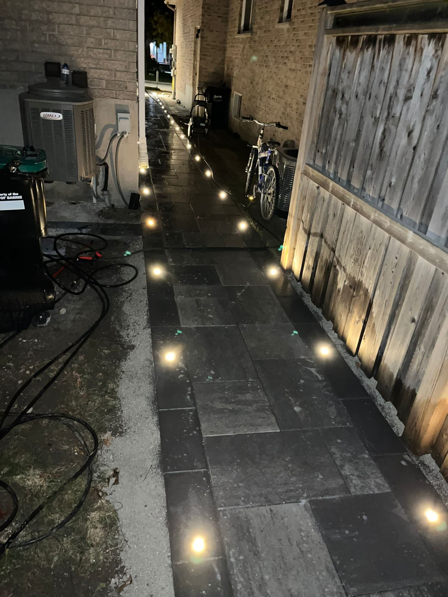 Path lights along paver walkway in Simcoe County at night