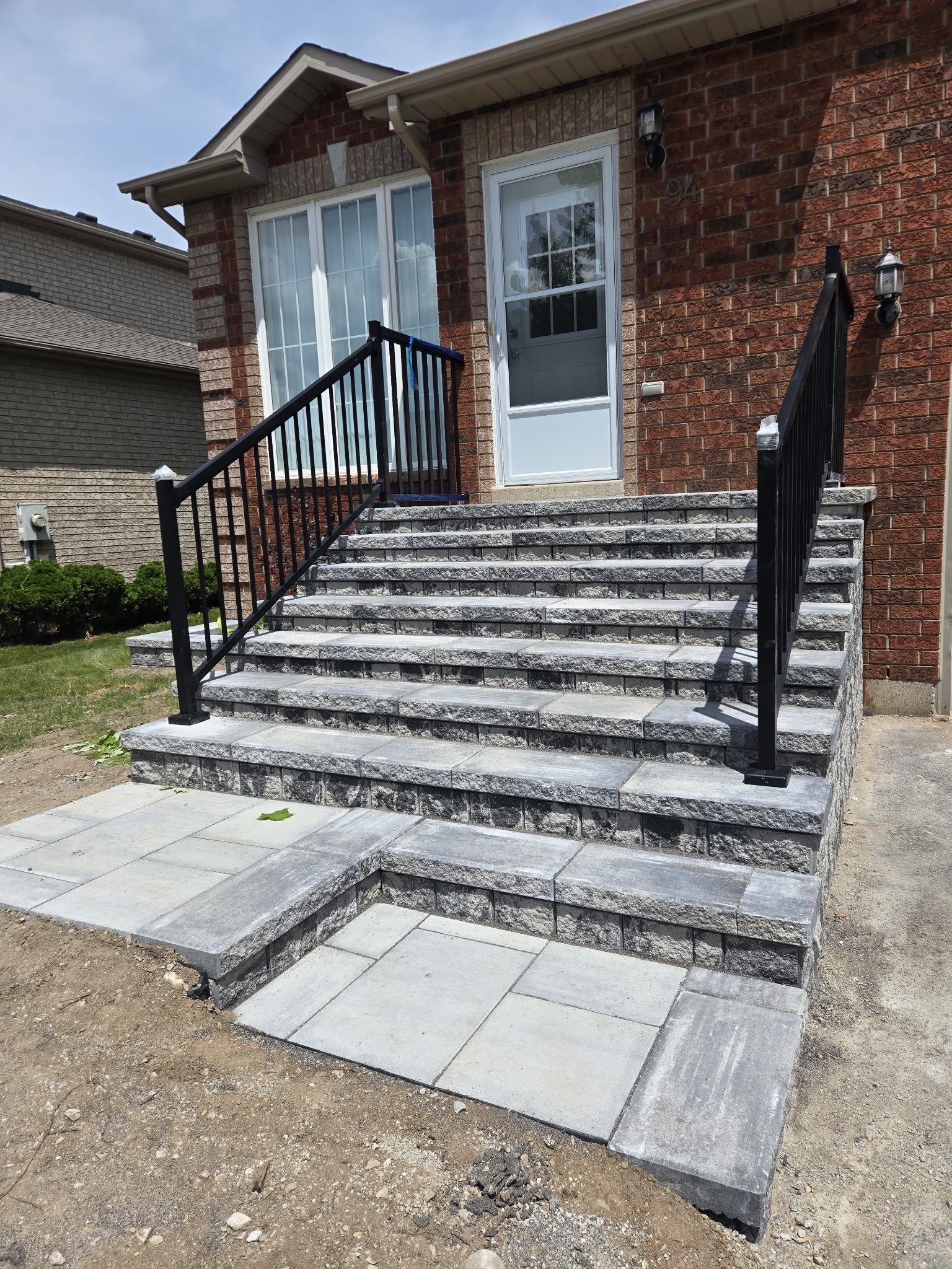 Stone front entrance steps with black railings, Barrie Ontario