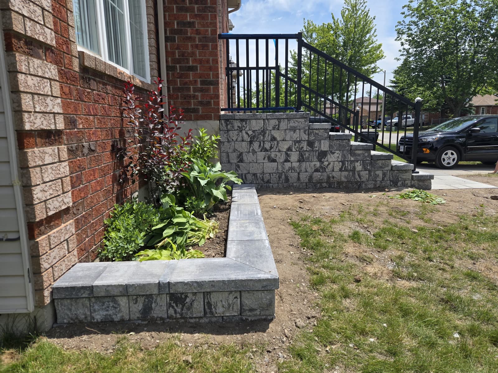 Stone retaining wall and garden bed with steps, Barrie landscaping