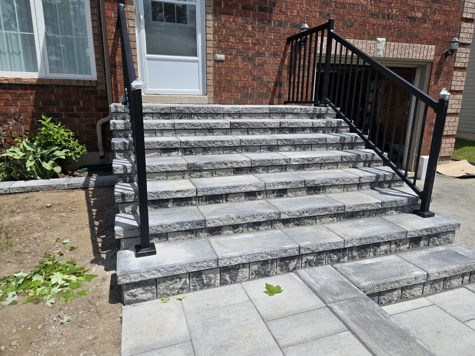 Natural stone steps with black metal railings, front entrance Barrie
